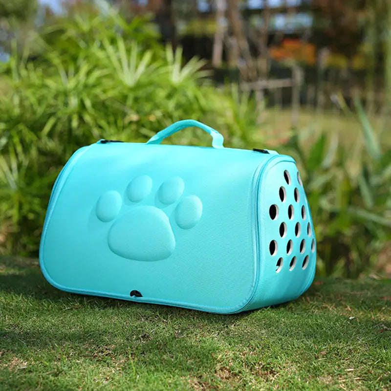 Light blue Eva folding pet carrier bag featuring a raised paw print design and circular ventilation holes.
