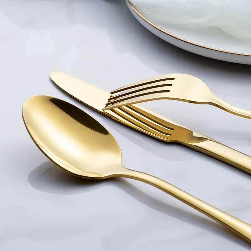 Rose gold stainless steel cutlery set featuring a golden spoon fork and knife with sleek modern design.