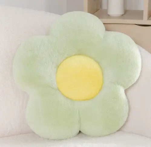 Un oreiller de taille en peluche souple à fleurs en forme de fleur vert menthe, avec un centre jaune vif, mesurant 45 cm, conçu comme un coussin tournesol.