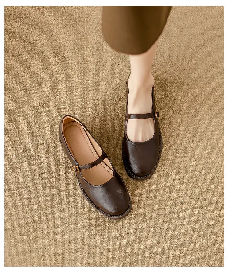 dark brown leather mary jane flats with a single strap and buckle across the instep designed as black leather mary jane shoes with a block heel
