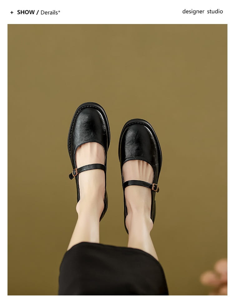 Black leather mary jane shoes with block heel featuring a simple strap and buckle detail.