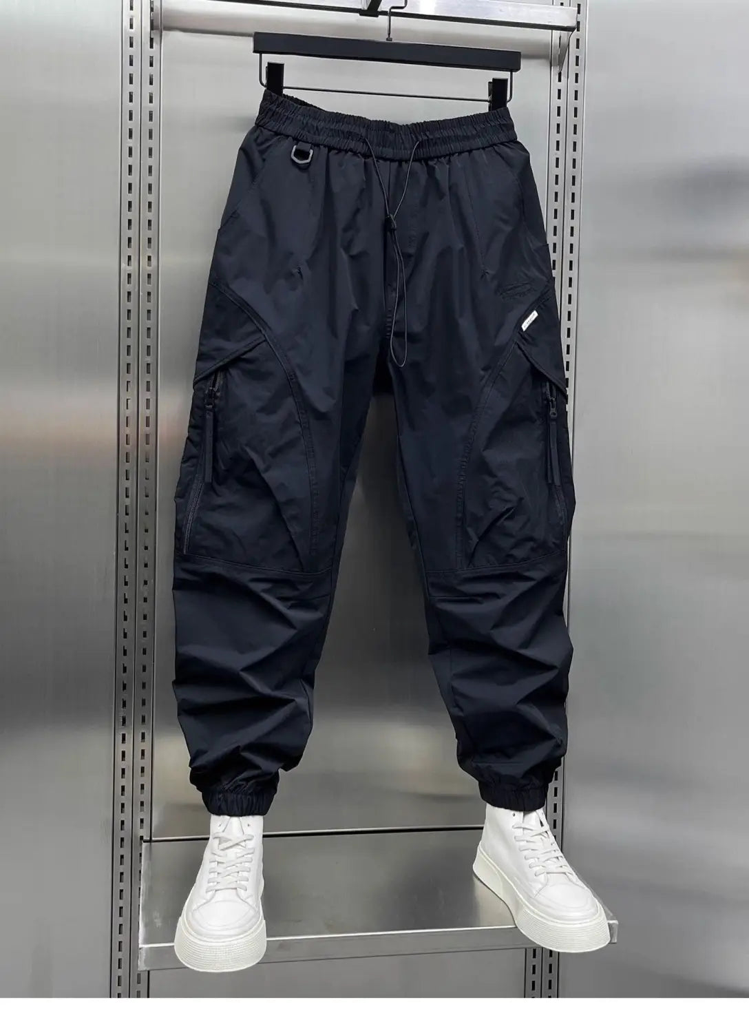 men’s tapered black cargo joggers made of lightweight nylon fabric with elastic waist drawstring and elastic cuffs