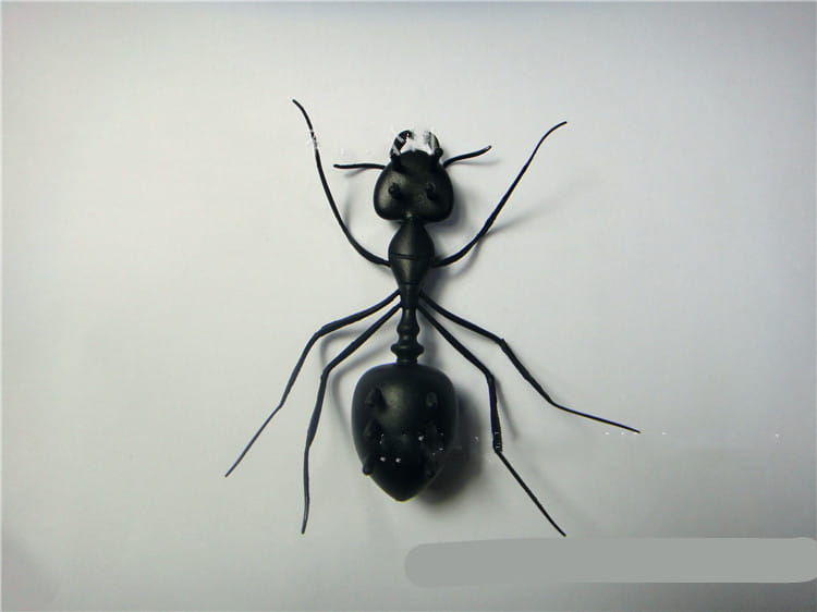 Black metal ant figurine with detailed segmented body and articulated legs in the solar ant electronic robot toy for kids 93mm.