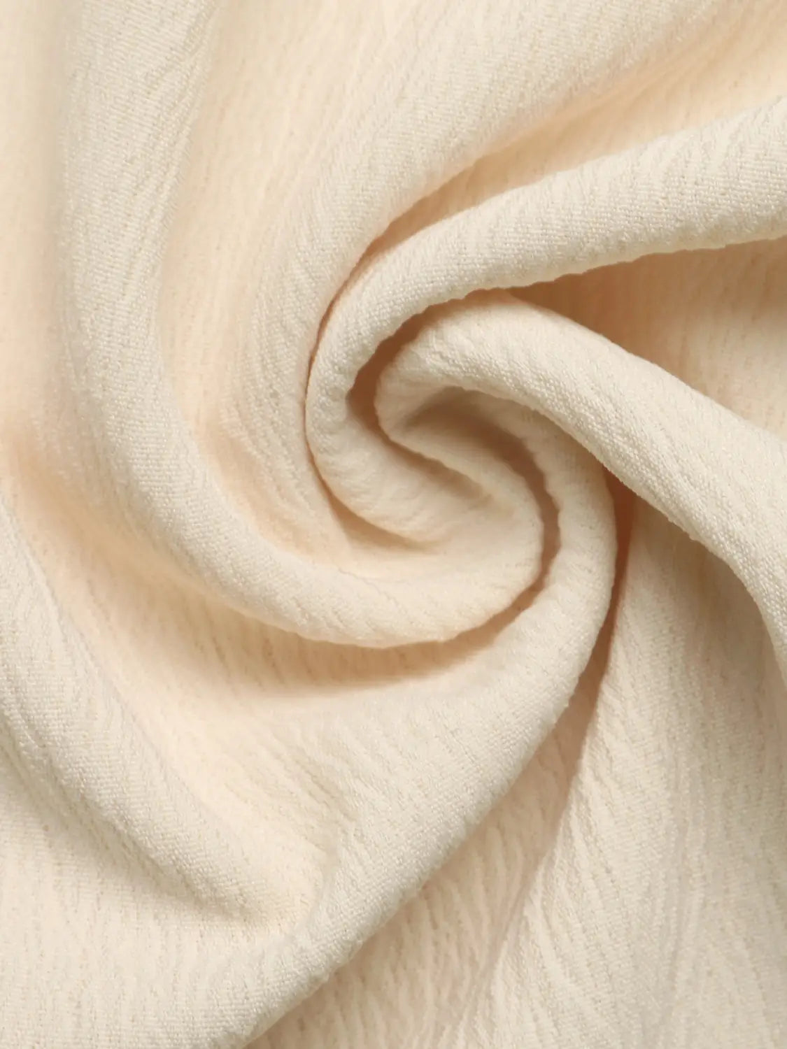 Cream strapless pleated jumpsuit made of cream-colored textured cotton fabric with a subtle crinkled surface.
