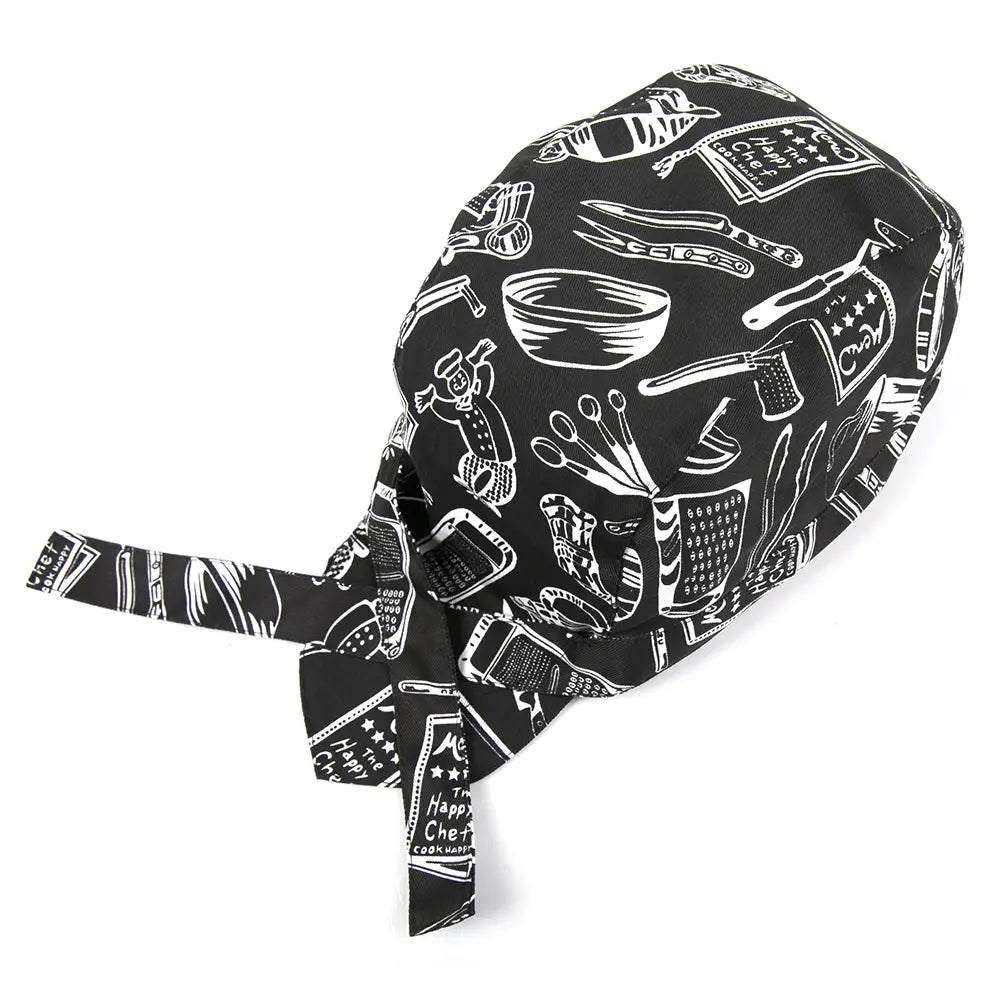 Black adjustable chef hat with white line drawings of kitchen utensils and the phrase the happy chef printed on it for kitchen work use.