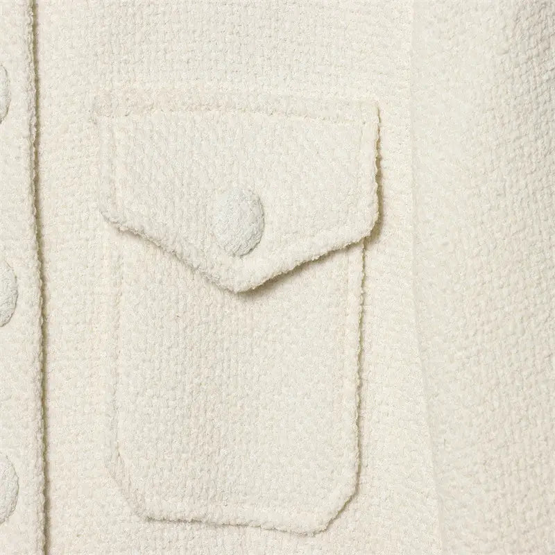 Cream tweed stand collar blazer featuring a cream-colored tweed pocket with a matching button closure.