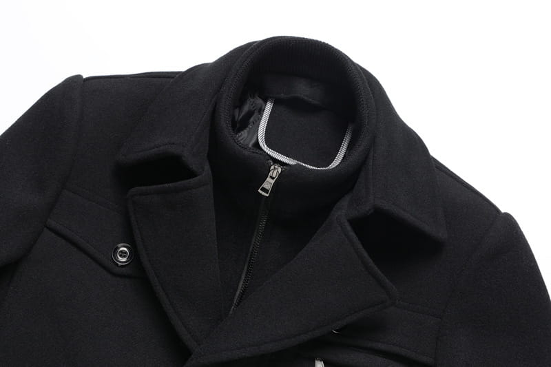 Black woolen men wool winter overcoat quilted jacket with a high collar and silver zipper detail.