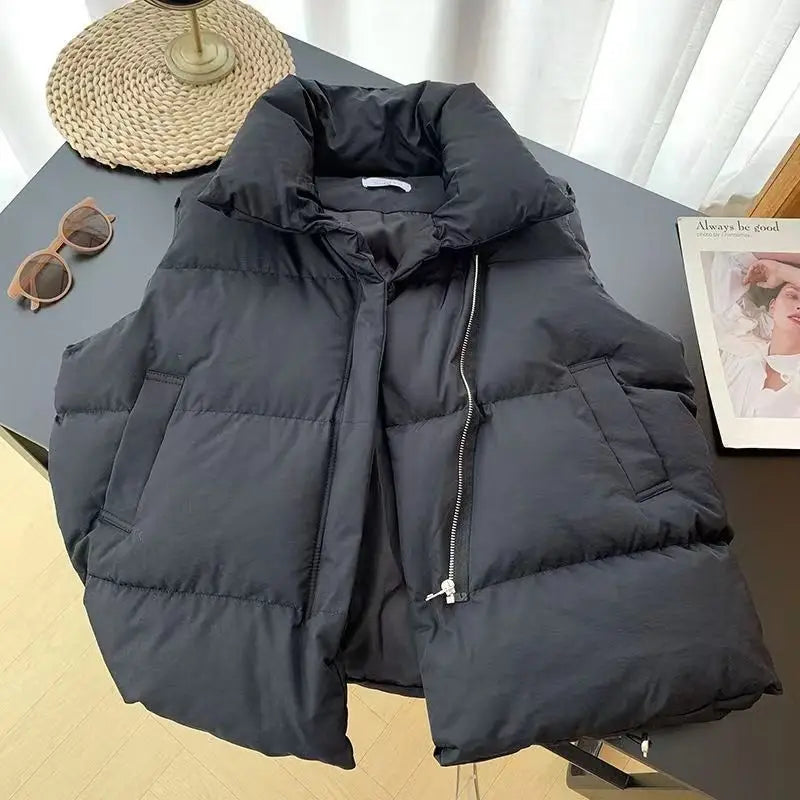 Black women quilted puffer vest with a loose fit sleeveless design and front zipper closure suitable for outerwear.