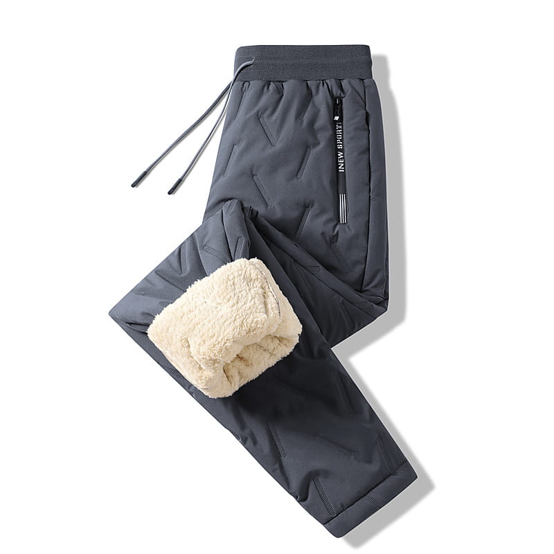 Thermal fleece lined winter joggers in dark gray quilted fabric with plush cream-colored fleece lining and a side zipper pocket featuring innew sport branding.