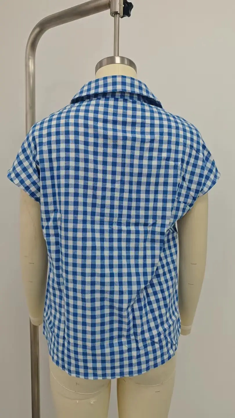 Blue and white gingham short-sleeved plaid button up blouse with front knot displayed on a mannequin.