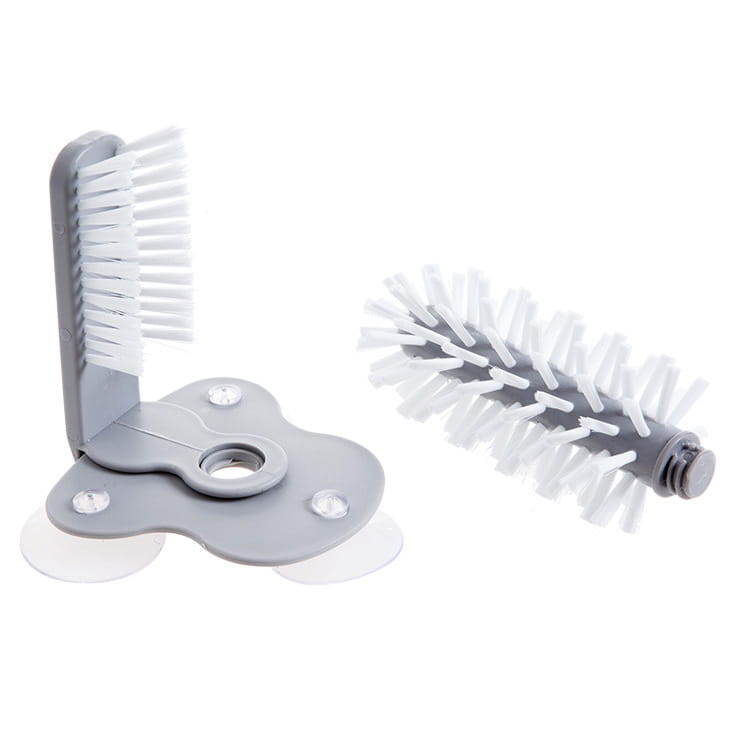 Gray plastic glass cleaning brush with white bristles and suction cups for wall mounting designed as a sink scrubber.