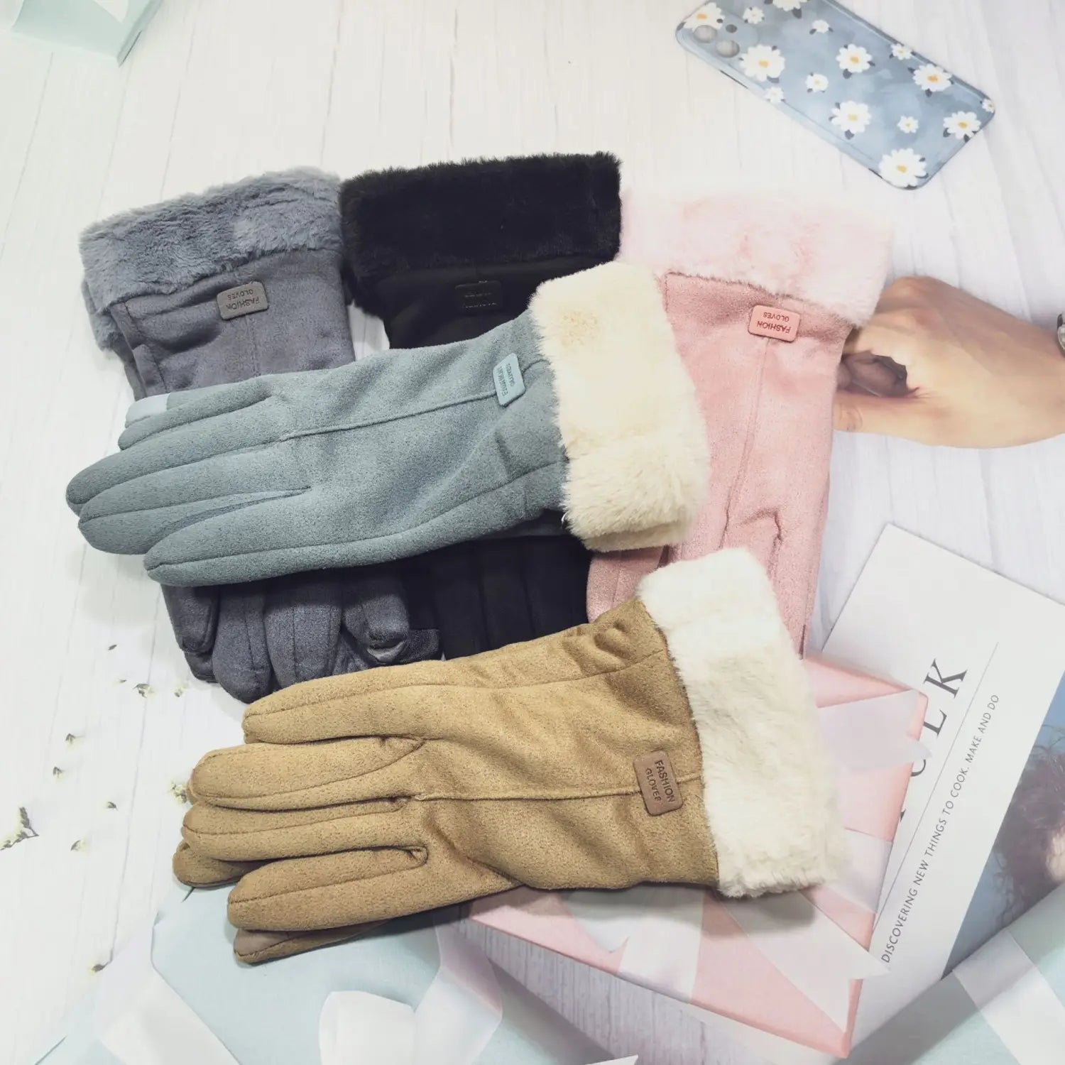A cozy pair of women’s thermal tan suede touchscreen gloves with plush white faux fur lining and a brown leather brand tag.