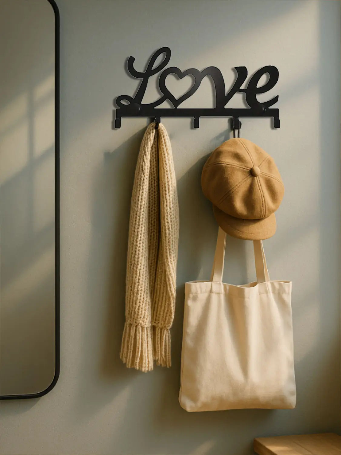 Black metal love wall hook with heart design featuring five pegs for keys or small items.