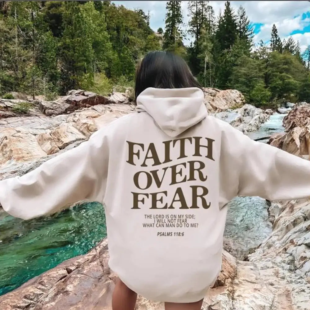 Beige faith over fear psalm 118 6 christian aesthetic hoodie showing the back side with bold brown lettering printed on soft material.