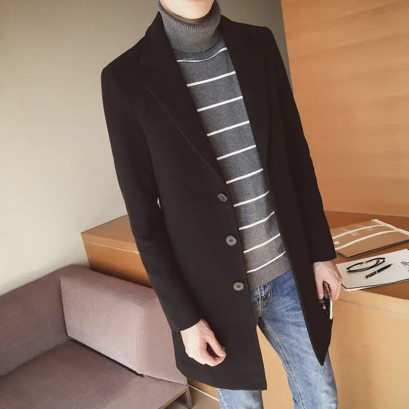 Black woolen overcoat with three dark buttons and classic notched lapel for mens slim wool trench coat Korean style.