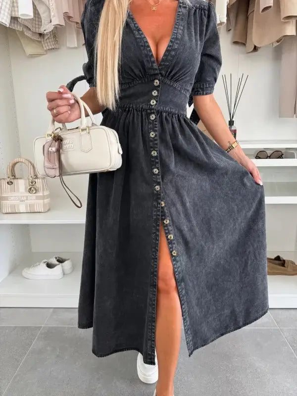 Dark denim midi dress with button-front detailing, puff sleeves, and a high slit.