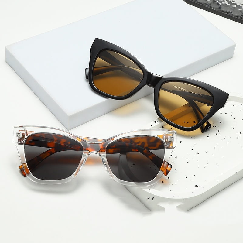Gafas de sol de moda retro con forma de ojo de gato con protección UV, con monturas carey negras y transparentes, y lentes con tonos ámbar.