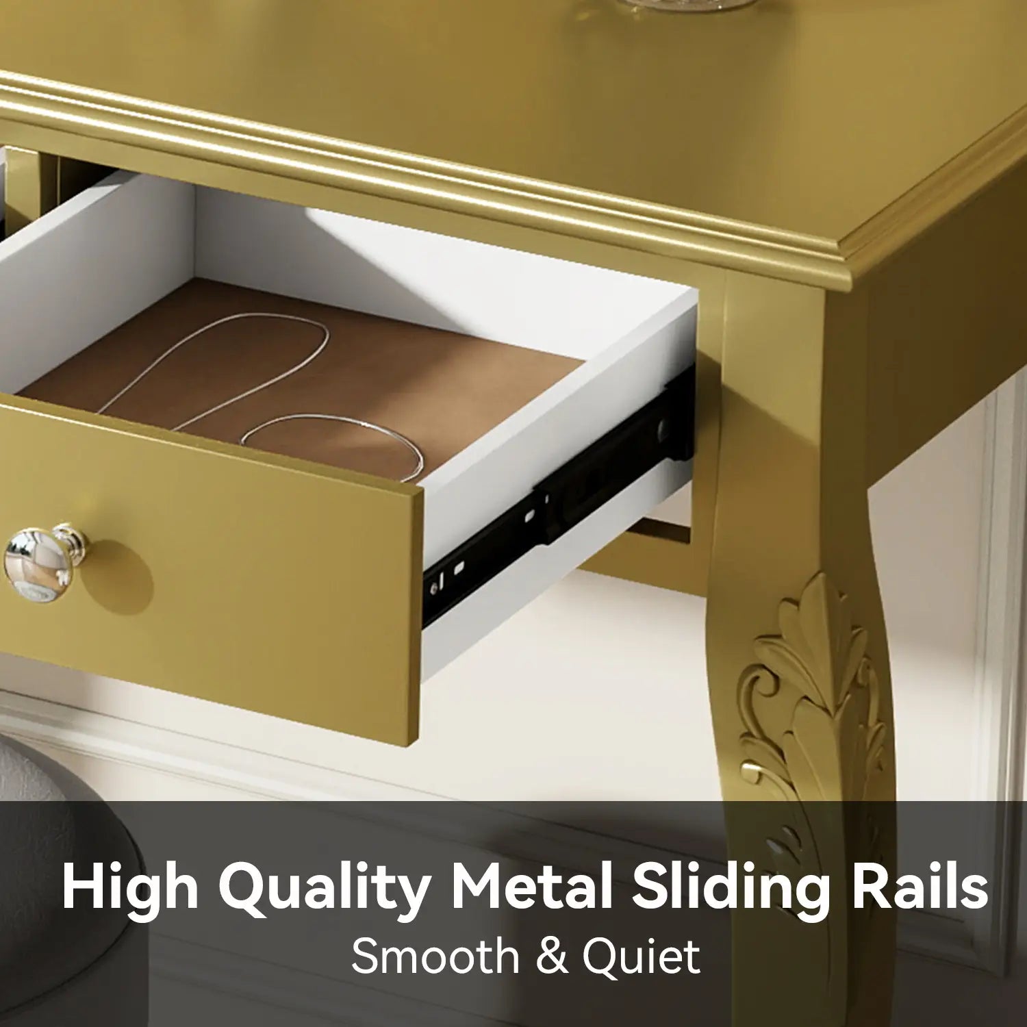 Gold makeup vanity desk with oval mirror and three drawers featuring a gold-finished wooden structure with ornate carvings and crystal knob drawer pulls.