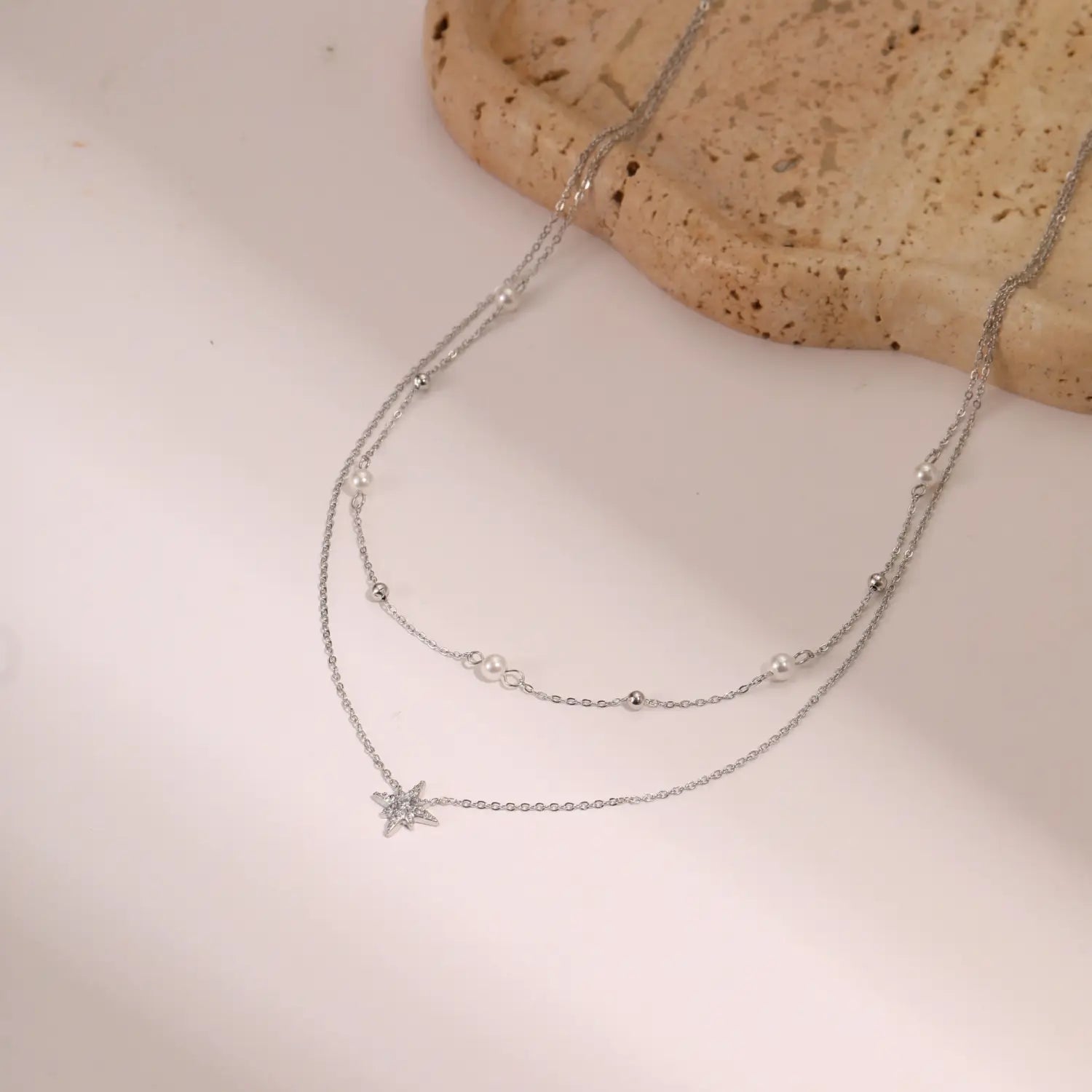 Silver double-strand 18k gold star and pearl stainless steel necklace featuring delicate chains, small pearls, metallic beads, and a sparkling star pendant.