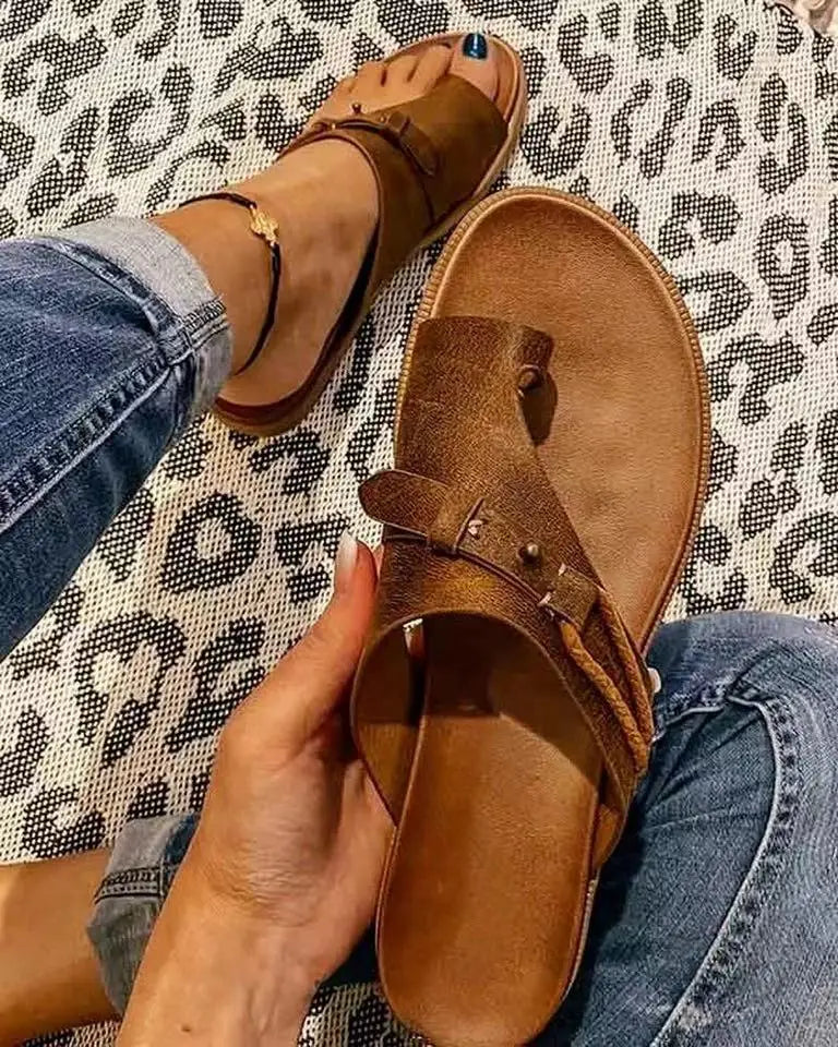 Women leather thong sandals in brown suede featuring a buckle strap and metallic studs for casual flat platform slides.