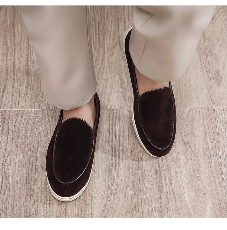 Dark brown suede men’s slip on loafers with a white rubber sole designed for comfort and casual wear.