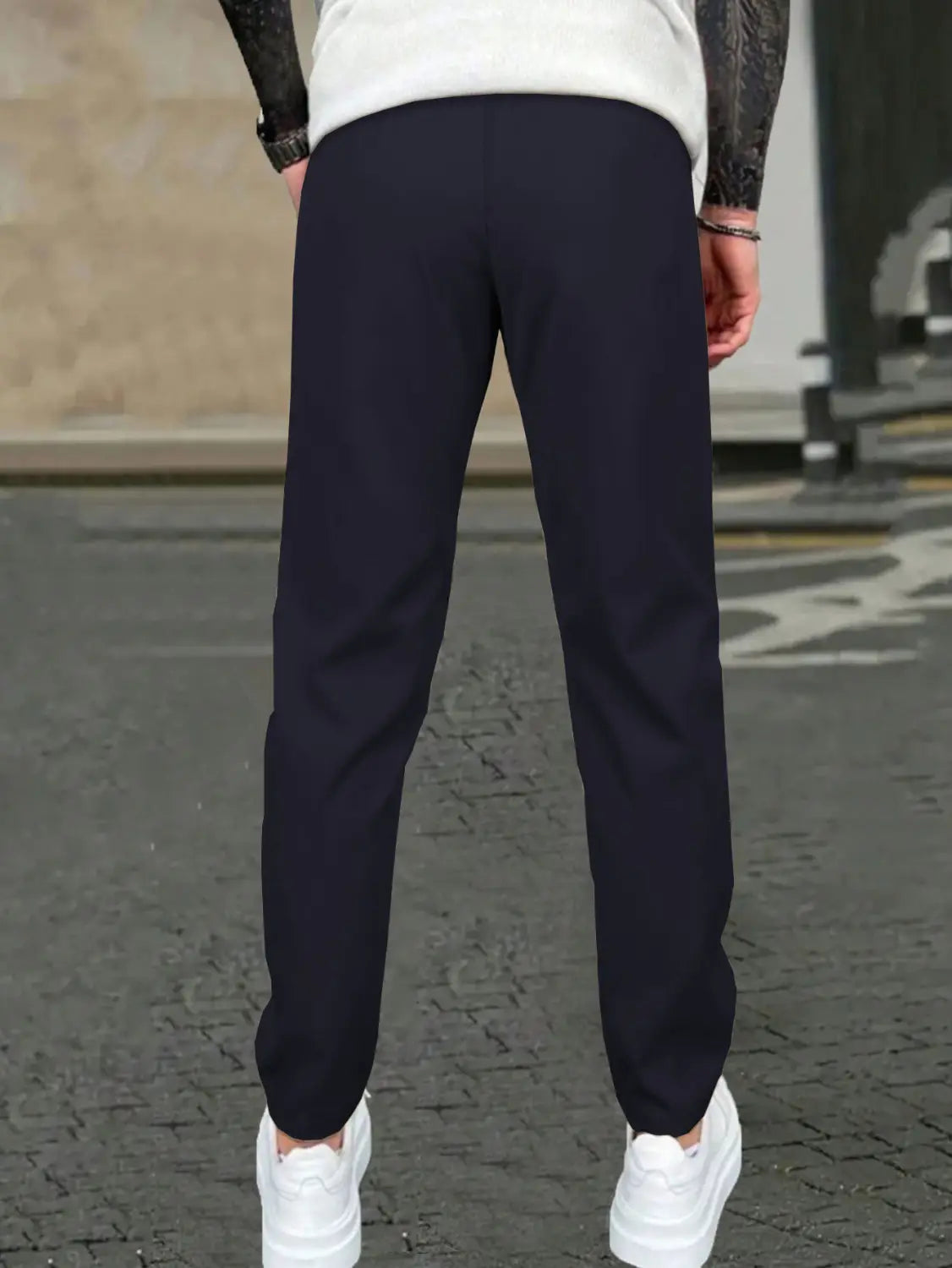 Slim fit tapered jogger pants in dark navy blue with smooth tailored fabric and subtle side seam detailing.