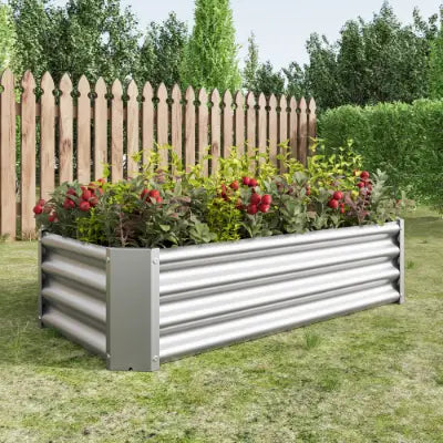 Lecho elevado de jardín de metal corrugado plateado, maceta galvanizada de 4x2x1 pies, que contiene plantas con flores rojas y verdes.