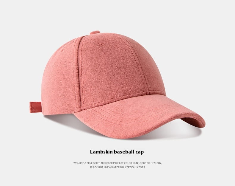 A soft pink suede baseball cap featuring lambskin material with a curved brim and an adjustable fabric strap.