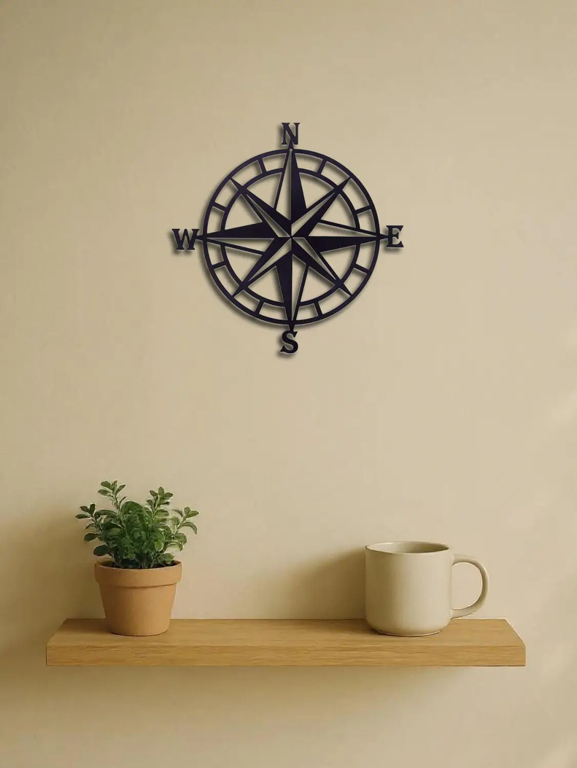 Black metal compass wall art 11 inch decor featuring engraved cardinal directions for nautical-themed interior decoration.