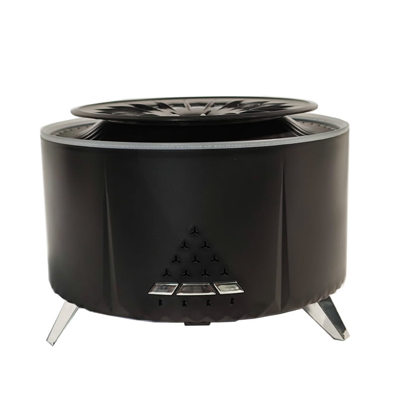 Black cylindrical portable fire pit with a starburst lid and three silver control buttons used as a white noise flame aroma diffuser and Bluetooth humidifier.