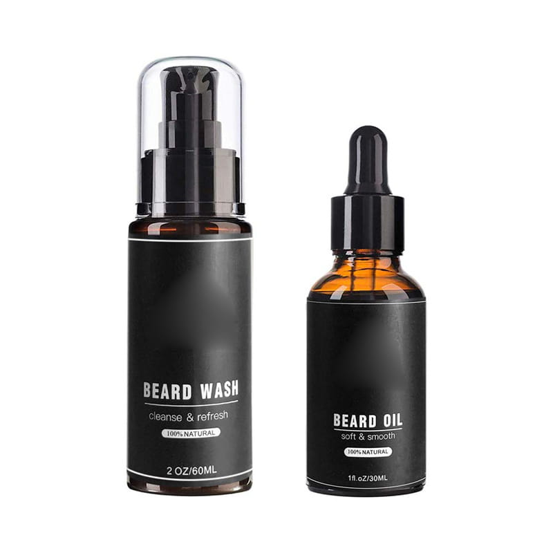 botellas de vidrio color negro con tinte, con etiquetas y tapas mate negras; una con dispensador con bomba para el lavado de barba y la otra con tapa cuentagotas para aceite de barba, parte de un kit de crecimiento de barba con dermaroller y herramientas de aseo.