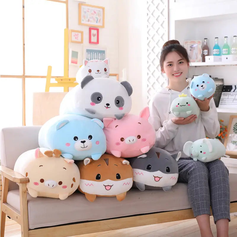 A collection of plush animal pillow soft cartoon dolls for kids in pastel colors featuring cute round faces and friendly expressions.
