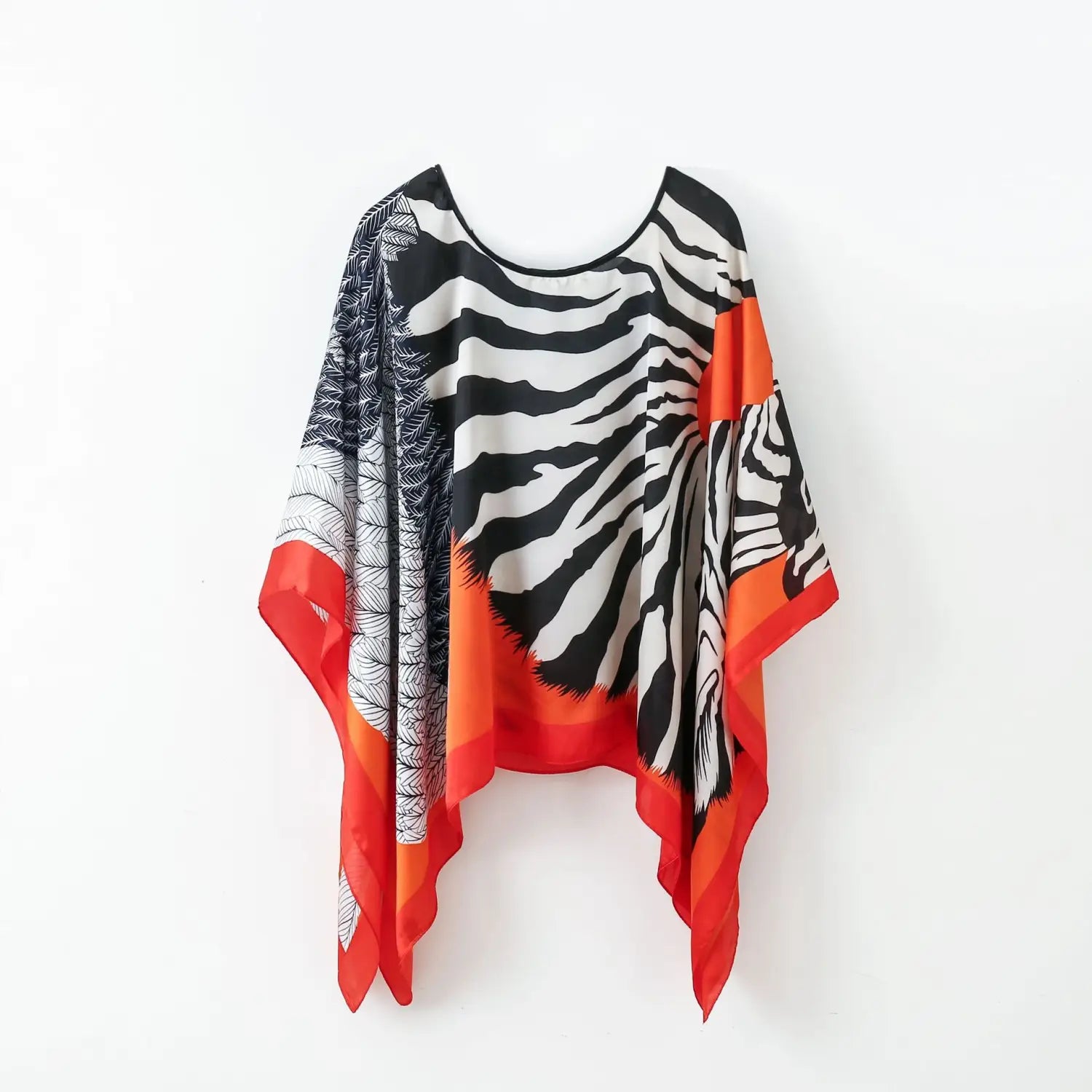 a flowing wide-sleeved printed silk patterned pullover shawl cape outerwear in bold zebra print with orange and black accents
