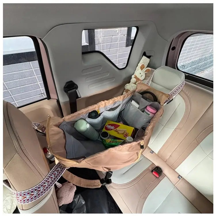 Beige and gray fabric car seat organizer made of waterproof nylon with multiple compartments for multifunctional storage in a fashion tote and backpack.