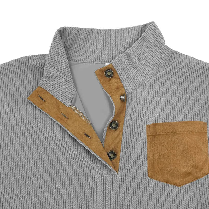 Slim fit corduroy patchwork pullover in gray with tan suede collar placket and pocket featuring contrast accents.