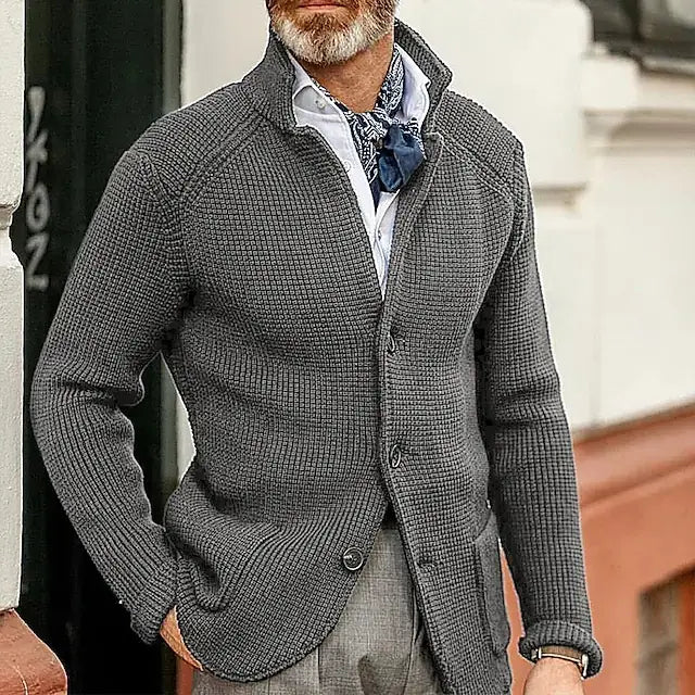 Cardigan en maille texturée gris foncé pour homme, à col montant et fermeture à bouton, conçu comme un pull tricoté.