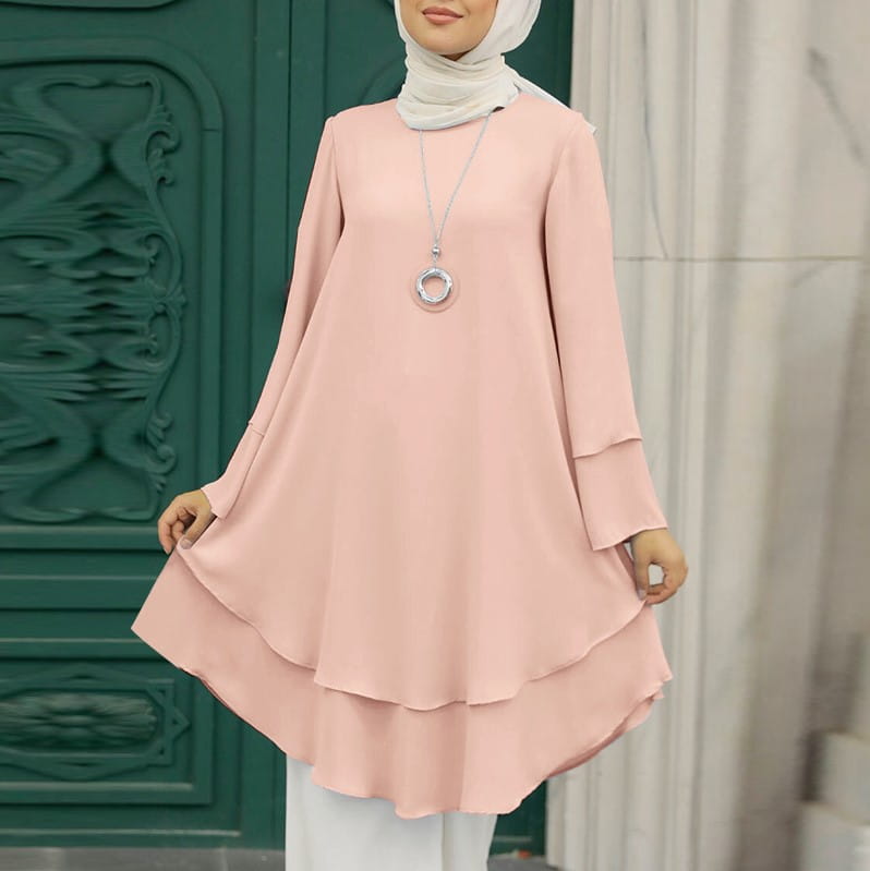 Ein zartes rosafarbenes langärmeliges, gestuftes Tuniken-Kleid mit fließender Silhouette und dezentem gerüschtem Saum, geeignet als einfarbiges Partykleid.