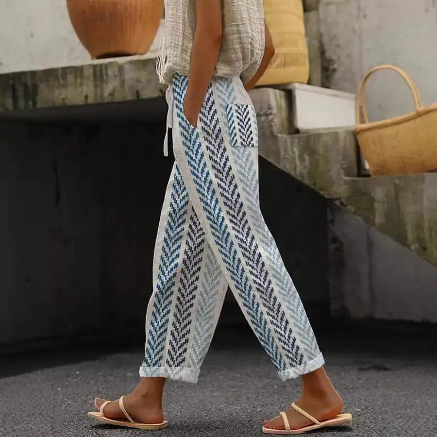 White linen casual patterned drawstring pocket pants with blue and gray leaf pattern side pockets and rolled cuffs