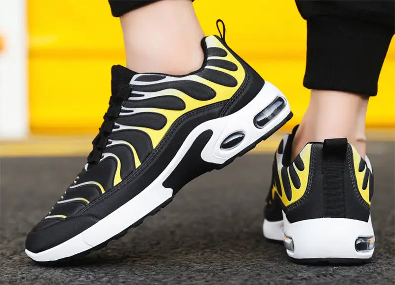 air cushion running shoes flame pattern fashion sneakers featuring black and yellow flame-patterned athletic design with white midsole and visible air cushioning units.