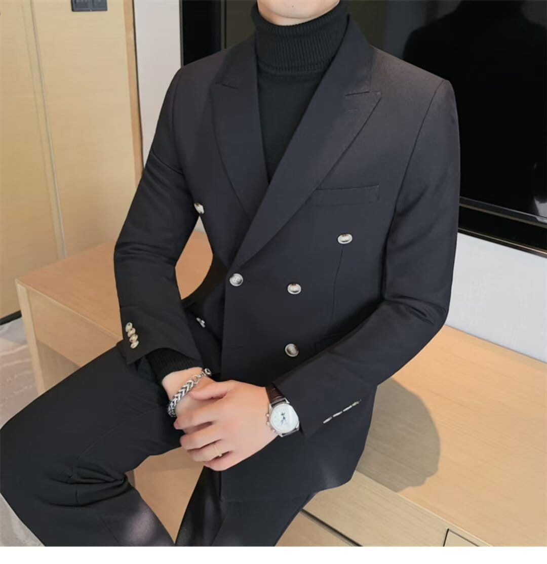 Black double breasted suit jacket with silver buttons and subtle stitching details complementing the teal double breasted corduroy jacket for men.