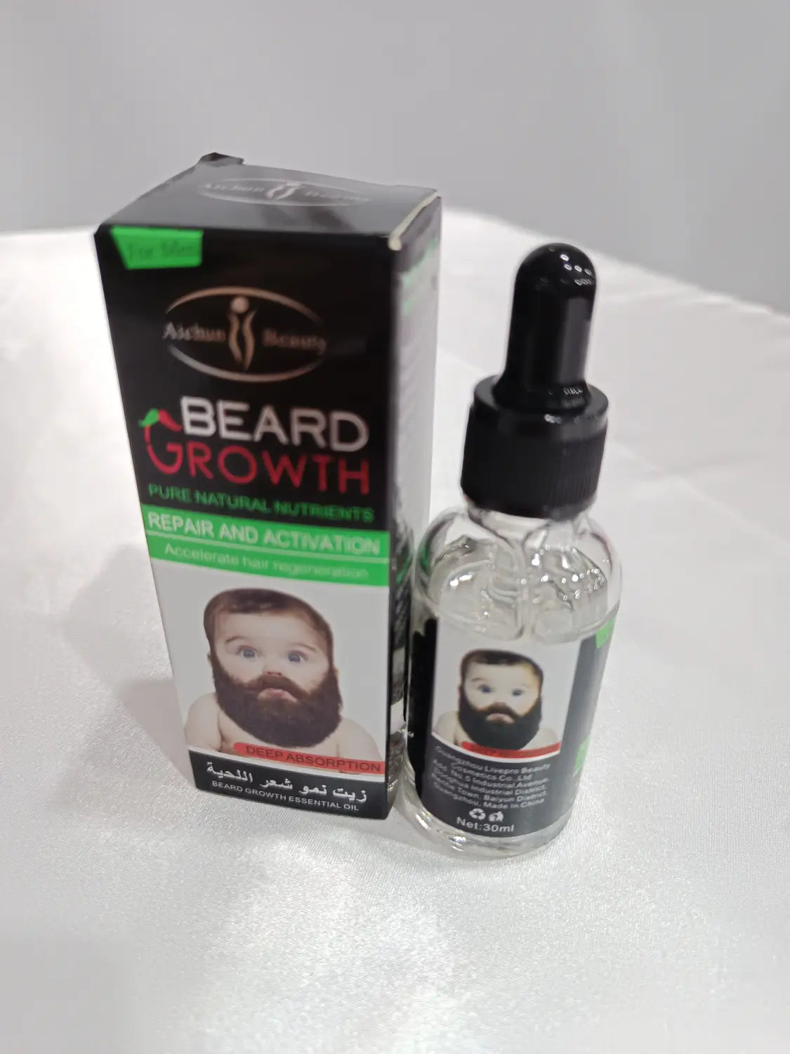 Clear glass bottle with black dropper cap and label featuring a baby’s face containing beard growth oil for natural repair and nourishing care.