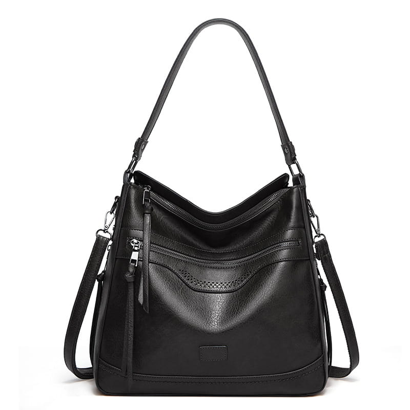 Schwarze Vintage-Ledertasche im Totebag-Stil mit strukturiertem Design, mehreren Reißverschlüssen und Riemen für vielseitige Schultervarianten.
