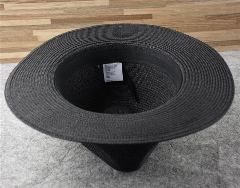 Black woven straw fedora hat with foldable design for sun protection suitable for men.