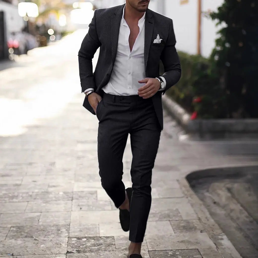 Men digital print casual suit set featuring a sharply tailored black suit jacket with a white dress shirt and patterned pocket square.