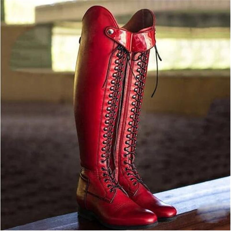 over the knee leather studded riding boots in vibrant red with black laces and silver eyelets.