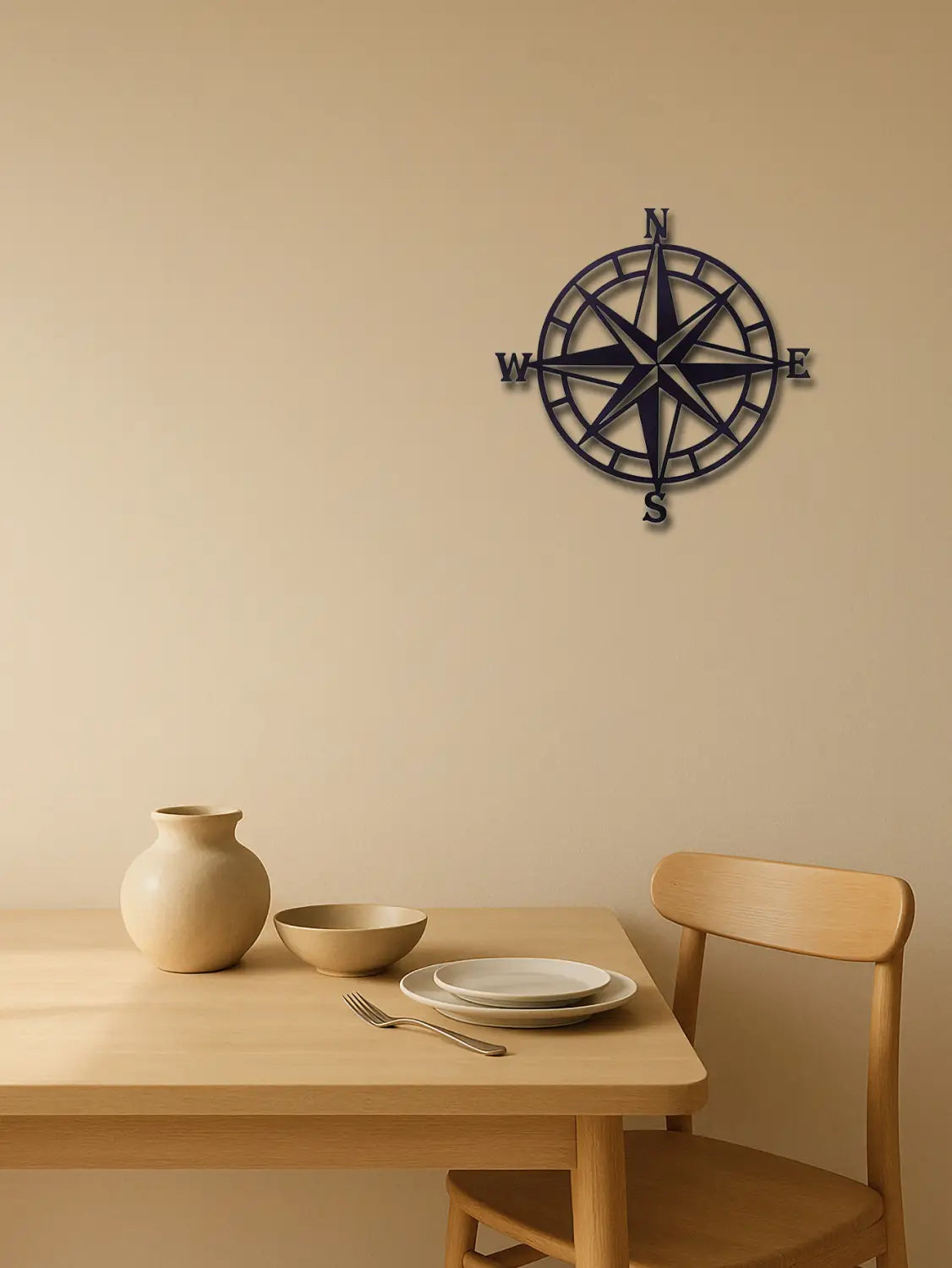 Black metal nautical compass wall art with engraved cardinal directions measuring 11 inch for home decor.
