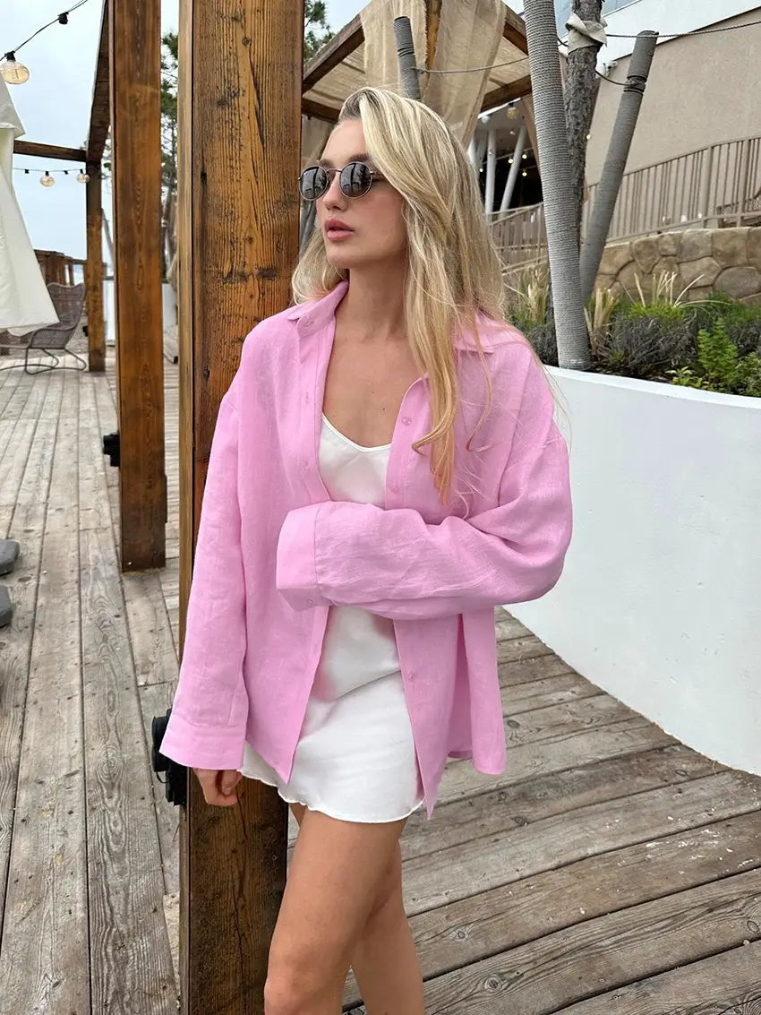 A soft pink oversized linen blazer with a relaxed fit and buttoned front featured as a women’s textured button up cardigan blouse.