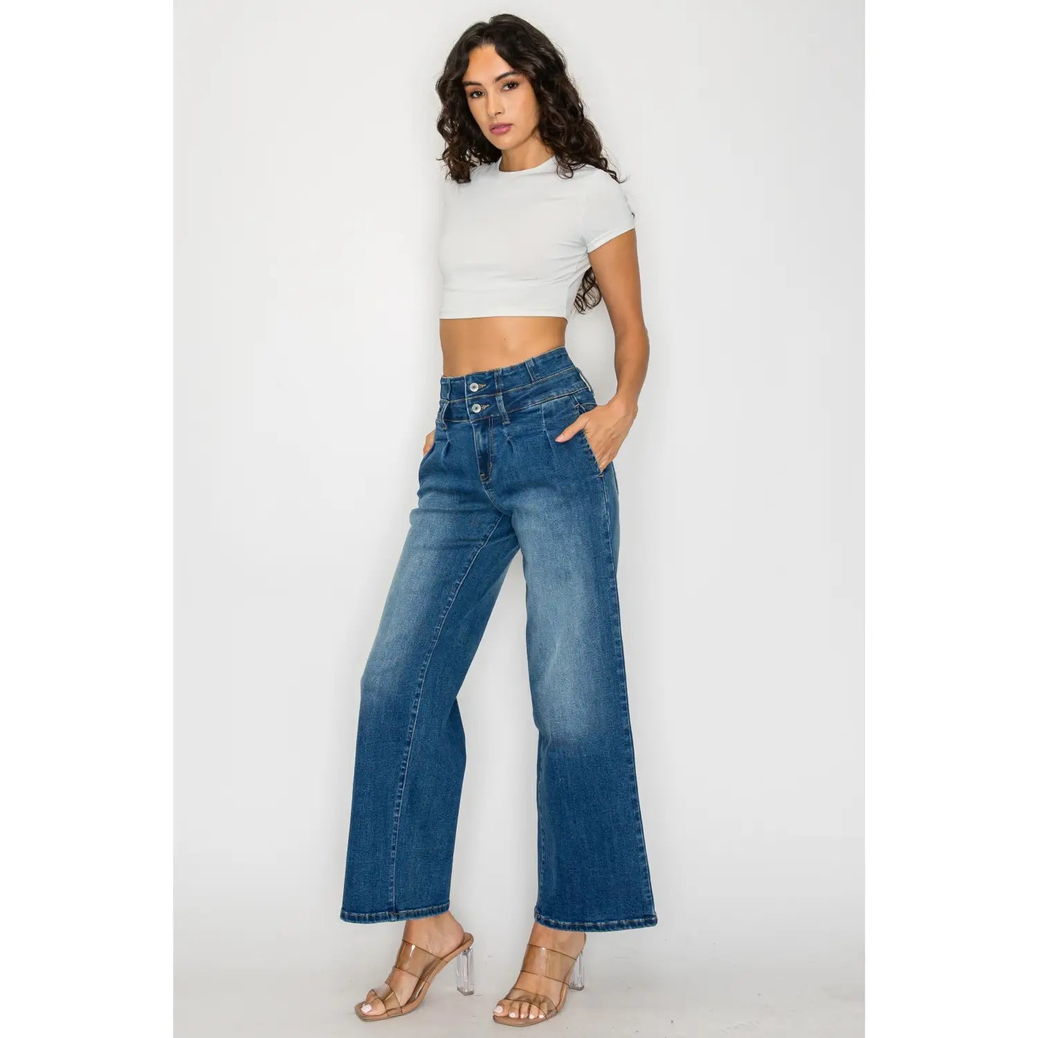 Medium blue wide leg denim jeans featuring a high-waisted fit with a double-button front closure.