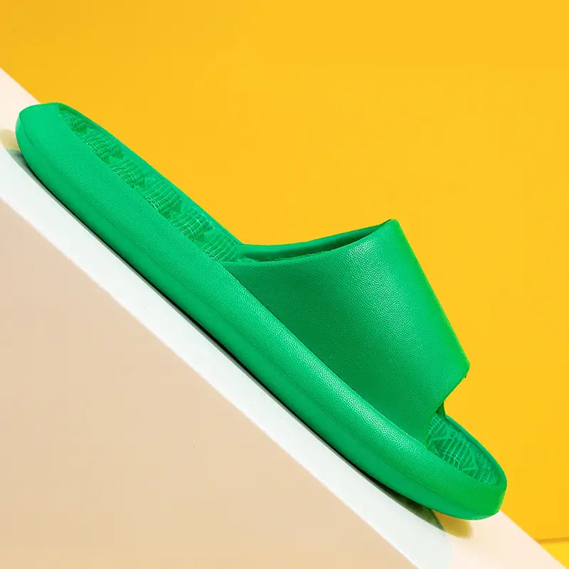 Bright green massage slippers honeycomb textured rubber slides with a smooth textured surface and contoured design.