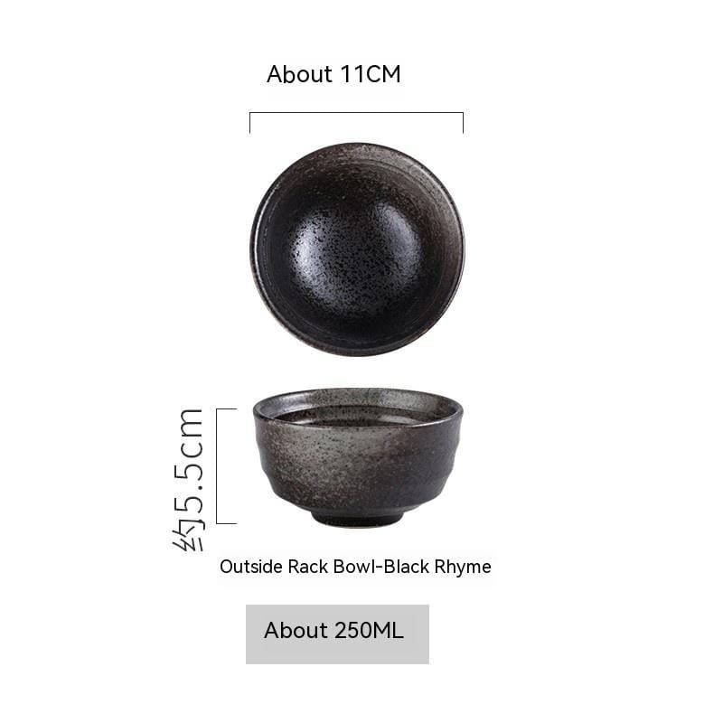 A dark speckled ceramic bowl with a rustic texture and slightly raised rim designed for porcelain rice tableware measuring four inches.